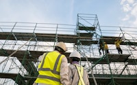Civil engineer and safety officer in spec steel truss structure scaffolding risk analysis in construction site