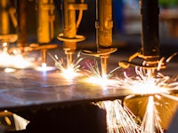 Close up shot of a CNC LPG cutting machine with sparks flying