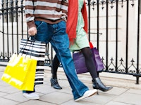 Retail couple carrying hopping bags 162609857