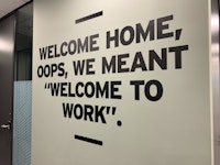 "Welcome Home, oops, we meant Welcome to work" wall sign/artwork at the London office.