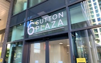 External shot of the London office showing the 6 Sutton Plaza on the glass above the automatic entry doors