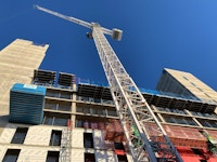 A low angle shot of a crane at the Hotel LaTour Construction